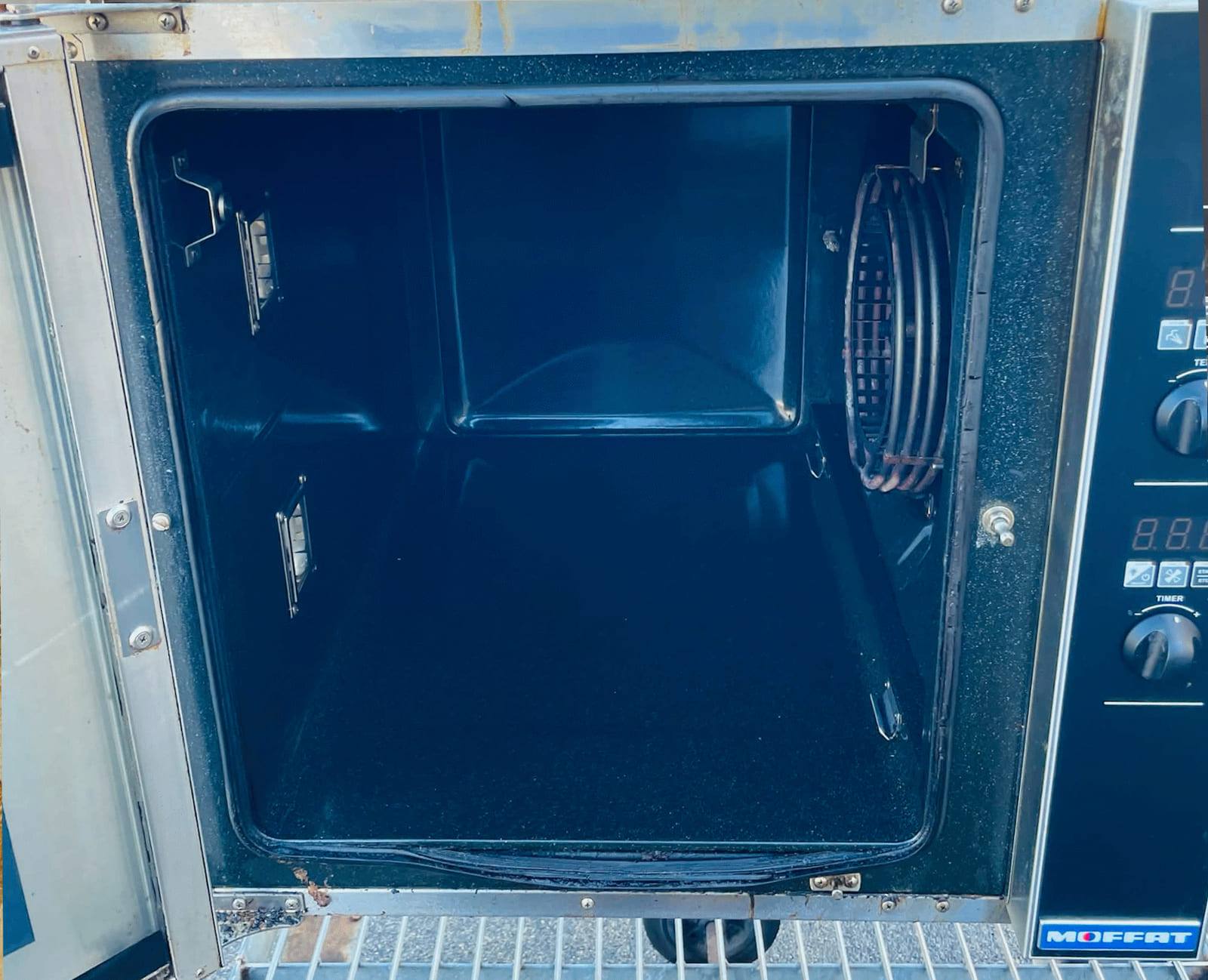 The same oven after cleaning, with the cavity stripped back to clean metal