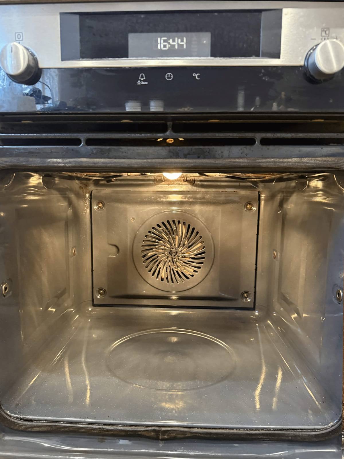 The same oven cavity at 16:44, cleaned back to bare metal with the fan cover clear