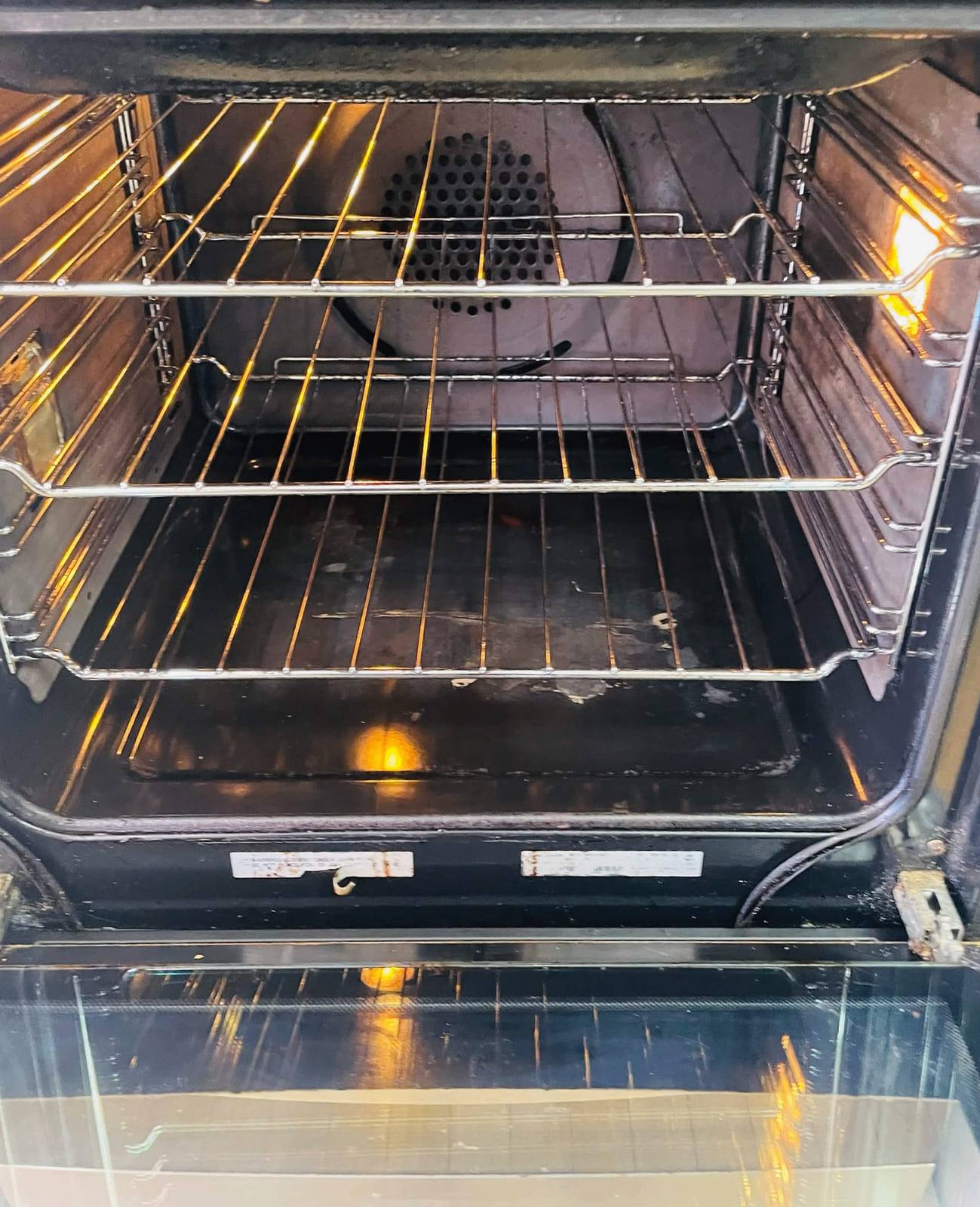 The same cavity after cleaning, with a clean fan cover and the door tray back to bare metal